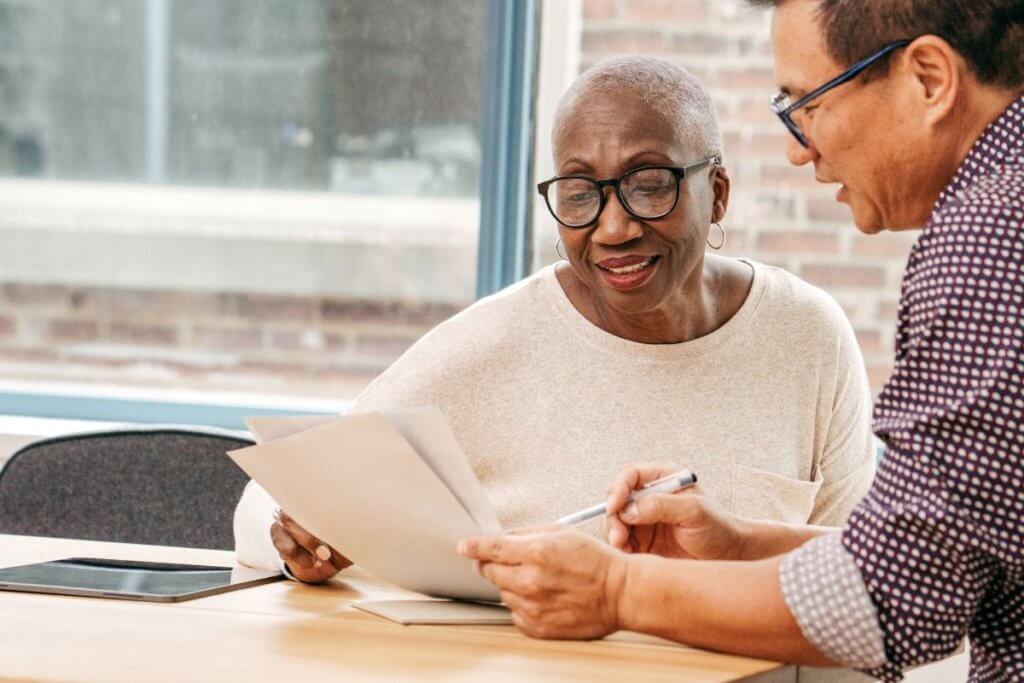 A man and woman discussing employee contract changes